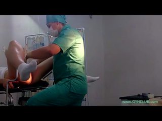 A girl in white socks on a gynecological chair